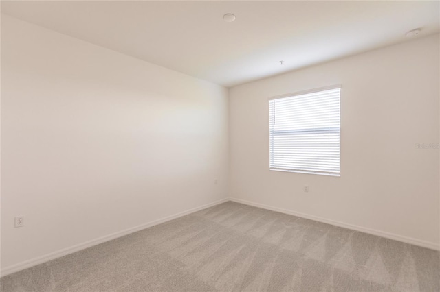 spare room with light colored carpet