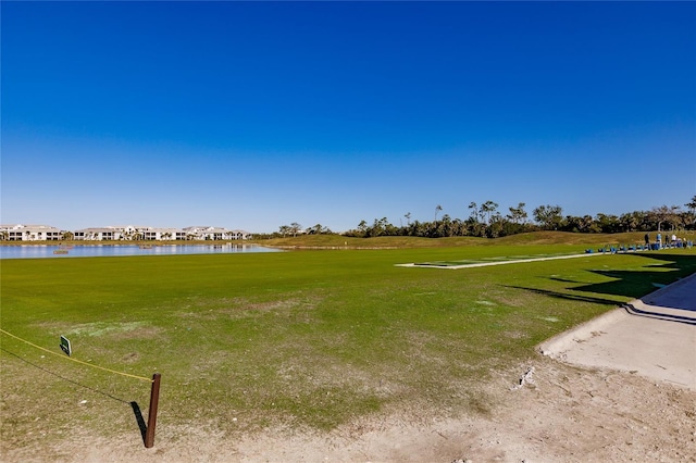 view of home's community featuring a yard and a water view