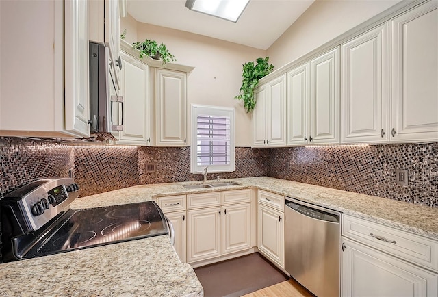 kitchen with tasteful backsplash, light stone countertops, sink, and stainless steel appliances