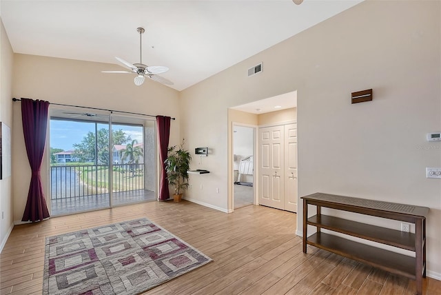 interior space with ceiling fan, light hardwood / wood-style floors, and lofted ceiling