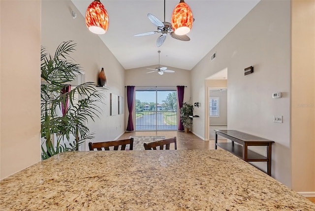 dining room featuring hardwood / wood-style floors, ceiling fan, and lofted ceiling