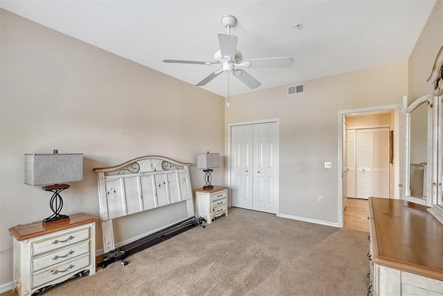 carpeted bedroom featuring ceiling fan and a closet