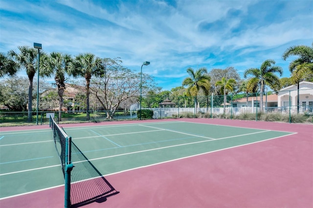 view of tennis court with basketball hoop