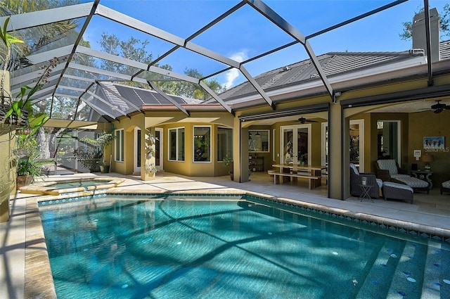 view of pool with a lanai, outdoor lounge area, a patio, and ceiling fan