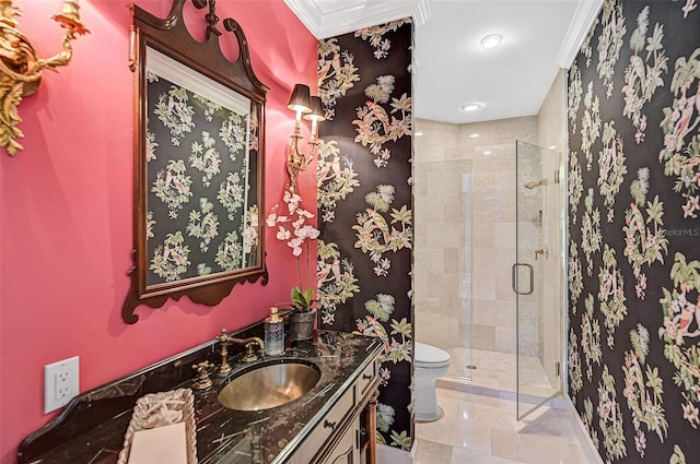 bathroom featuring crown molding, a shower with door, vanity, tile patterned floors, and toilet