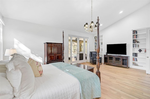 bedroom featuring lofted ceiling, a notable chandelier, light wood-type flooring, and french doors