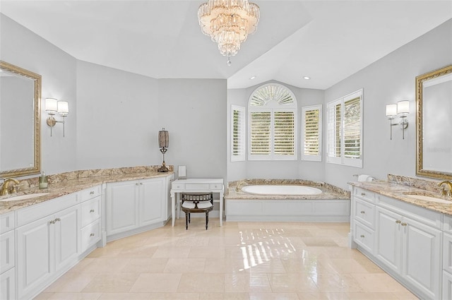 bathroom featuring vanity, lofted ceiling, a chandelier, and a tub to relax in