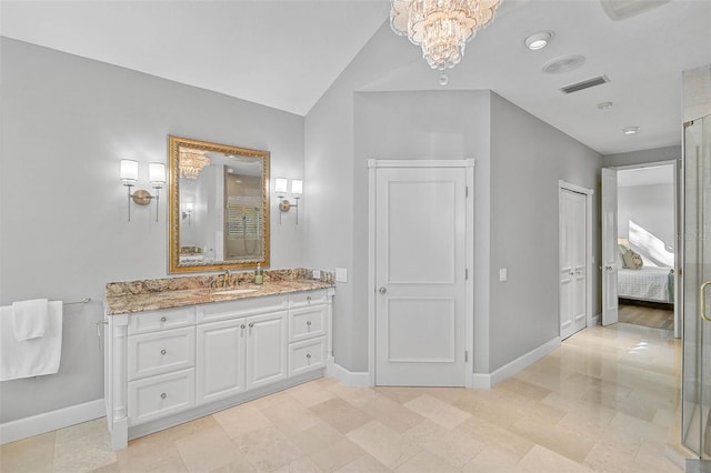 bathroom with vanity, lofted ceiling, and a chandelier