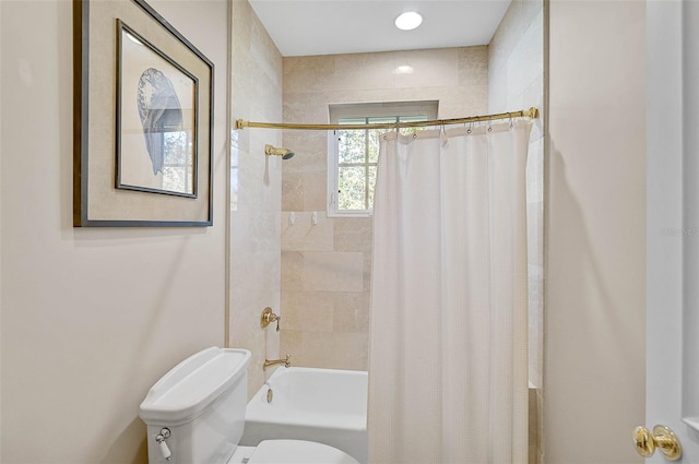 bathroom featuring shower / tub combo and toilet