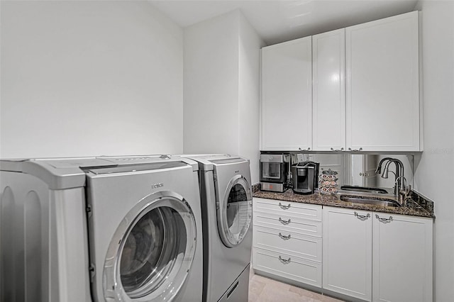 washroom with sink and washing machine and clothes dryer