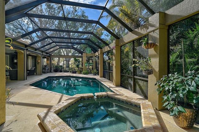 view of swimming pool featuring an in ground hot tub, a patio area, and glass enclosure