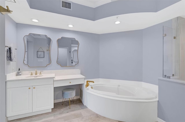 bathroom with vanity, wood-type flooring, and a bathtub