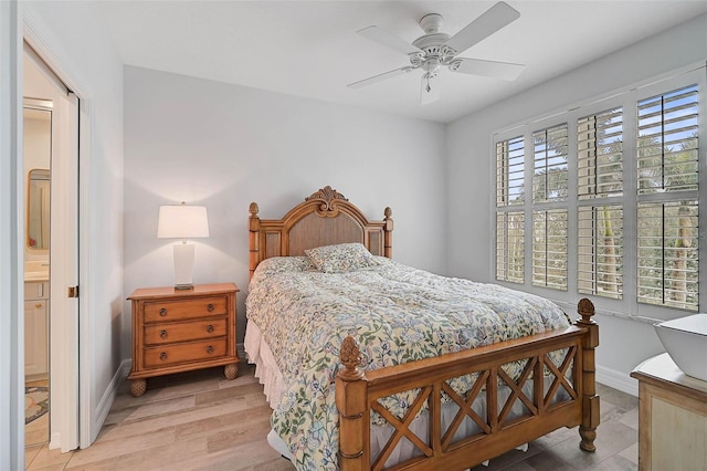 bedroom with ceiling fan, connected bathroom, and light hardwood / wood-style floors