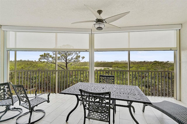 sunroom / solarium with ceiling fan and a healthy amount of sunlight