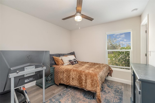 bedroom featuring ceiling fan and dark hardwood / wood-style flooring