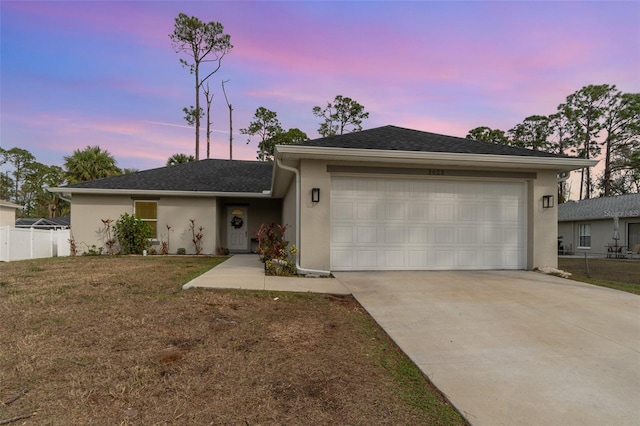 view of front of house with a lawn and a garage