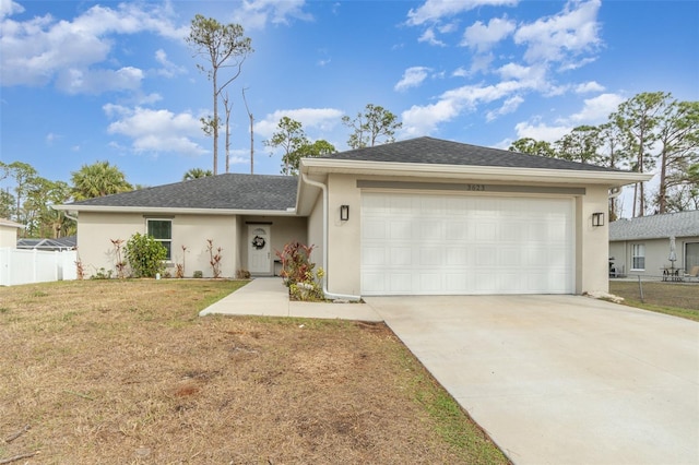 view of front of house featuring a front yard and a garage