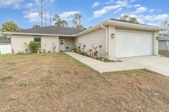 ranch-style home with a front yard and a garage