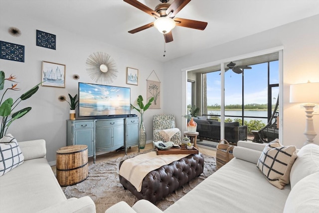 living room featuring hardwood / wood-style floors and ceiling fan