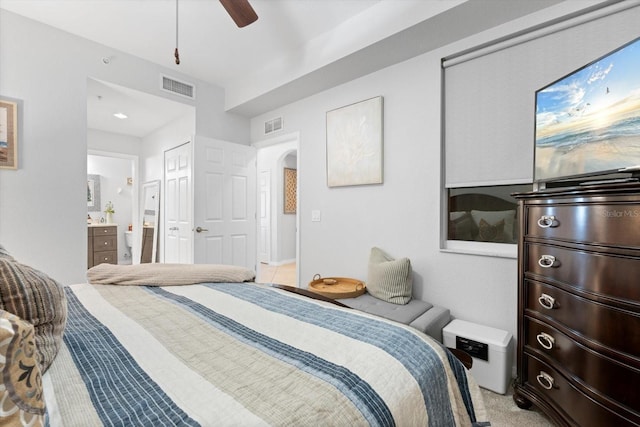 carpeted bedroom featuring connected bathroom, a closet, and ceiling fan