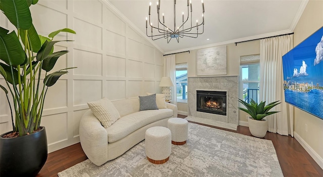 living area with dark hardwood / wood-style floors, ornamental molding, and a fireplace