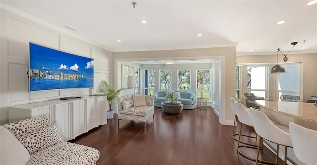 living room with dark wood-type flooring and ornamental molding