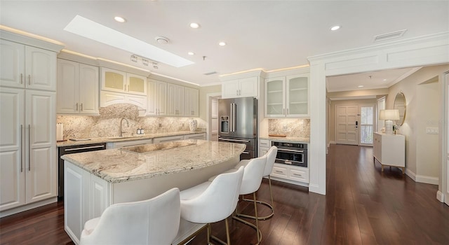 kitchen with a center island, stainless steel appliances, and white cabinetry