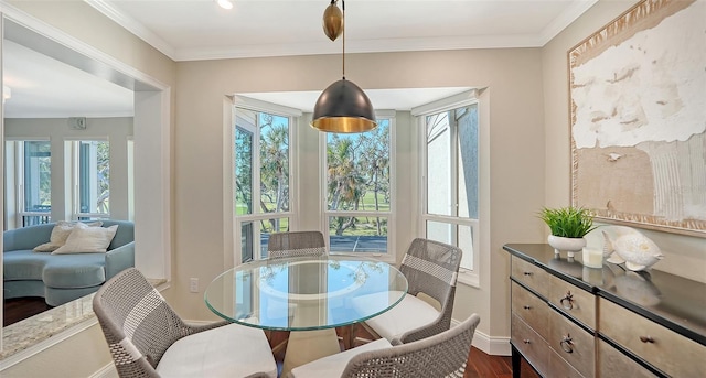 dining room with plenty of natural light, dark hardwood / wood-style flooring, and ornamental molding