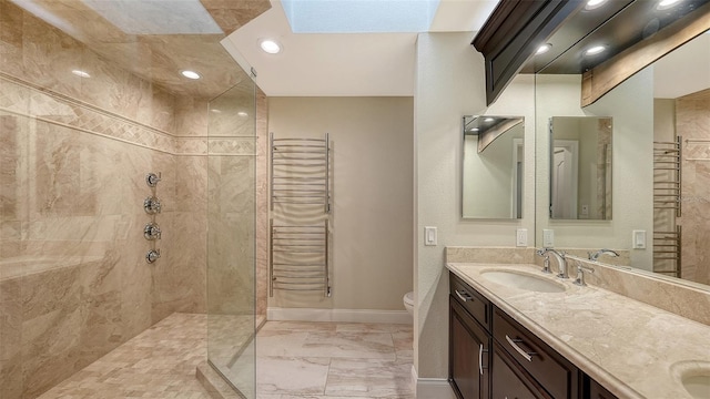 bathroom featuring tiled shower, vanity, a skylight, and toilet