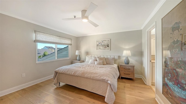 bedroom featuring ceiling fan, ensuite bath, crown molding, and light hardwood / wood-style flooring