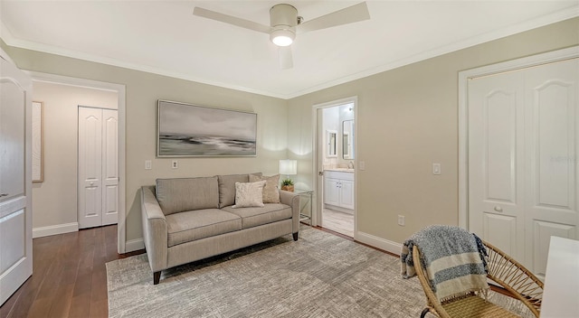 living room featuring hardwood / wood-style flooring, ceiling fan, and ornamental molding