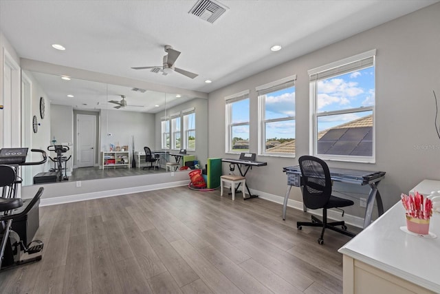 office space featuring ceiling fan and light wood-type flooring