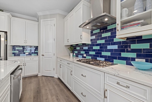 kitchen featuring decorative backsplash, appliances with stainless steel finishes, white cabinetry, and exhaust hood