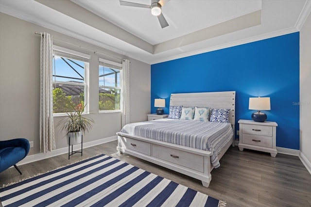 bedroom featuring ceiling fan, dark hardwood / wood-style floors, and a raised ceiling