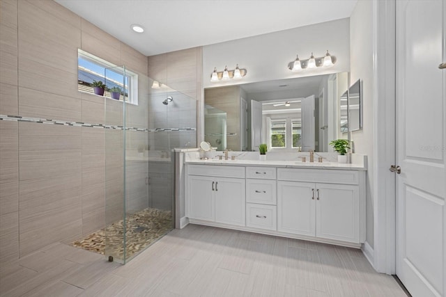 bathroom featuring vanity and tiled shower