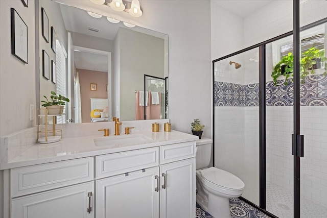 bathroom featuring vanity, toilet, and a shower with door