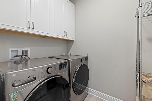 washroom with cabinets and washing machine and dryer