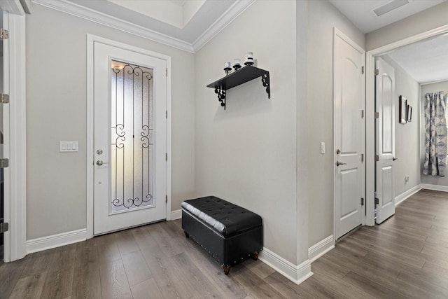 foyer with hardwood / wood-style flooring and crown molding