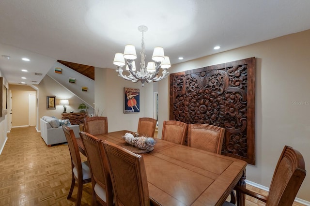 dining area featuring light parquet floors and a chandelier