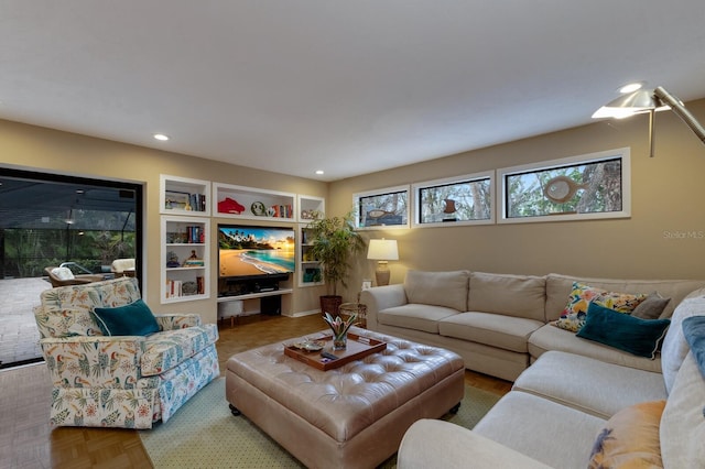 living room featuring built in features and parquet flooring