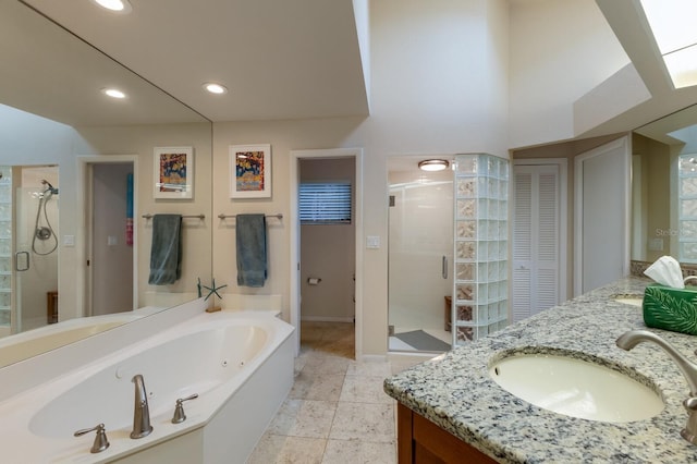 bathroom featuring vanity and shower with separate bathtub