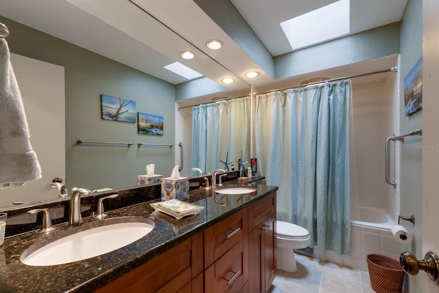 full bathroom with toilet, a skylight, shower / tub combo with curtain, tile patterned flooring, and vanity