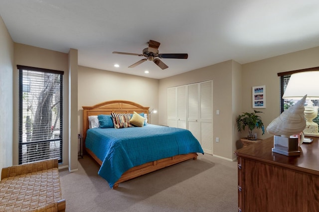 carpeted bedroom with ceiling fan, multiple windows, a closet, and access to outside