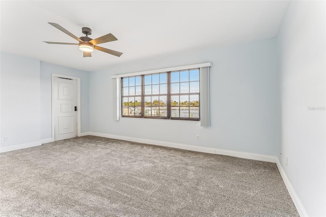 carpeted empty room featuring ceiling fan