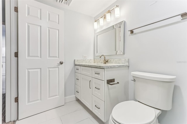 bathroom featuring toilet, tile patterned floors, and vanity