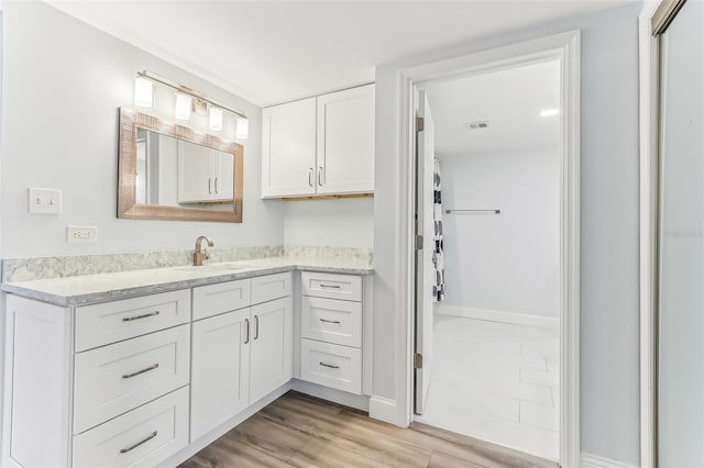 bathroom with vanity and hardwood / wood-style flooring