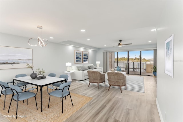 dining room with ceiling fan and light hardwood / wood-style flooring