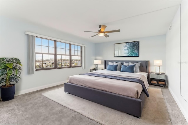 bedroom with ceiling fan and light colored carpet