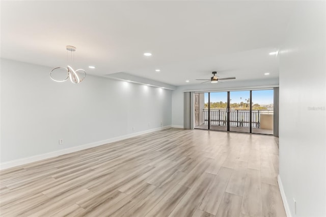 unfurnished room with ceiling fan and light hardwood / wood-style floors