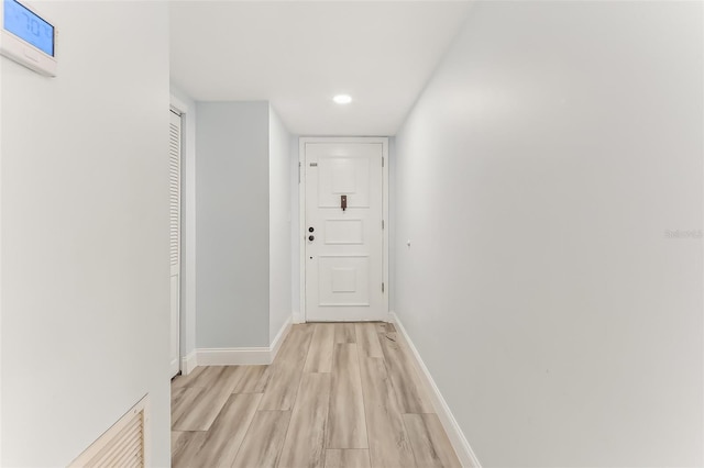 hall with light hardwood / wood-style floors